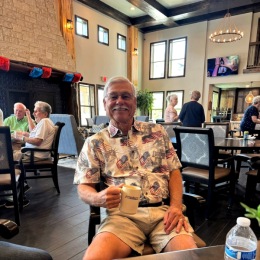 a person with a drink in a lounge decorated for 4th of july