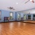 a large room with wood floors and a mirror