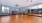 a large room with wood floors and a mirror