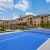 a tennis court with a building in the background