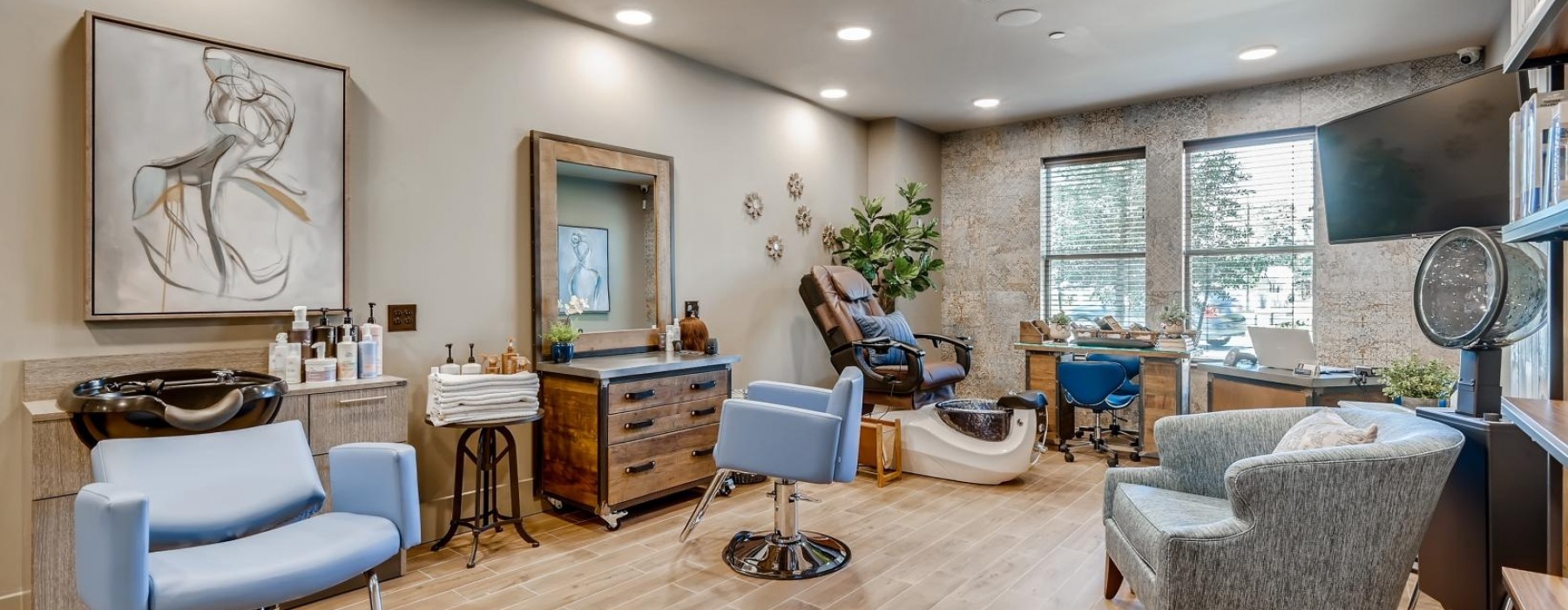 a salon room with a table chairs and a mirror