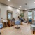 a salon room with a table chairs and a mirror