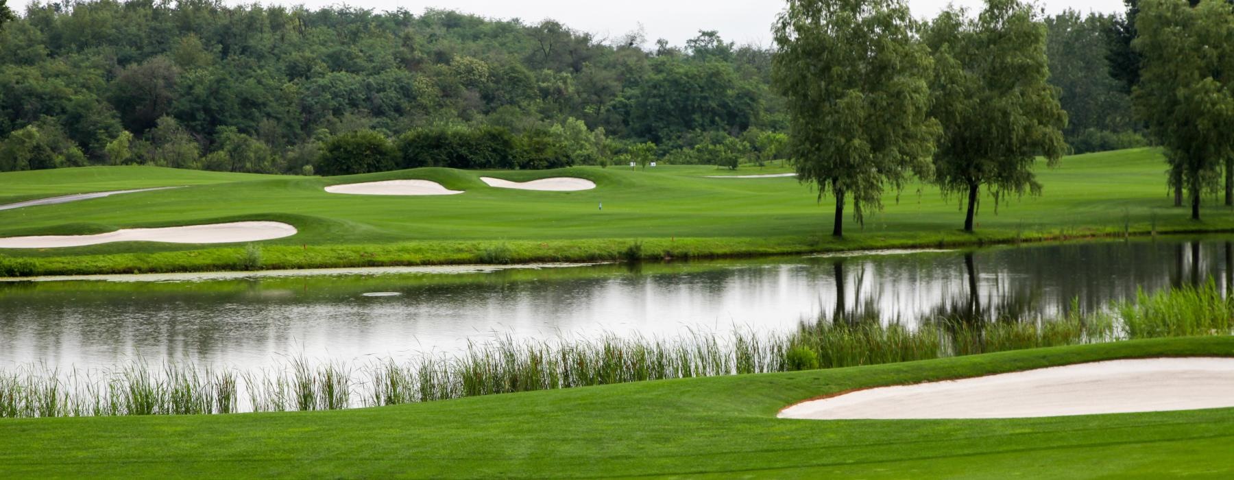 a golf course with a pond